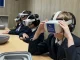 Police officers supervising students using virtual reality gear during an interactive safety session.